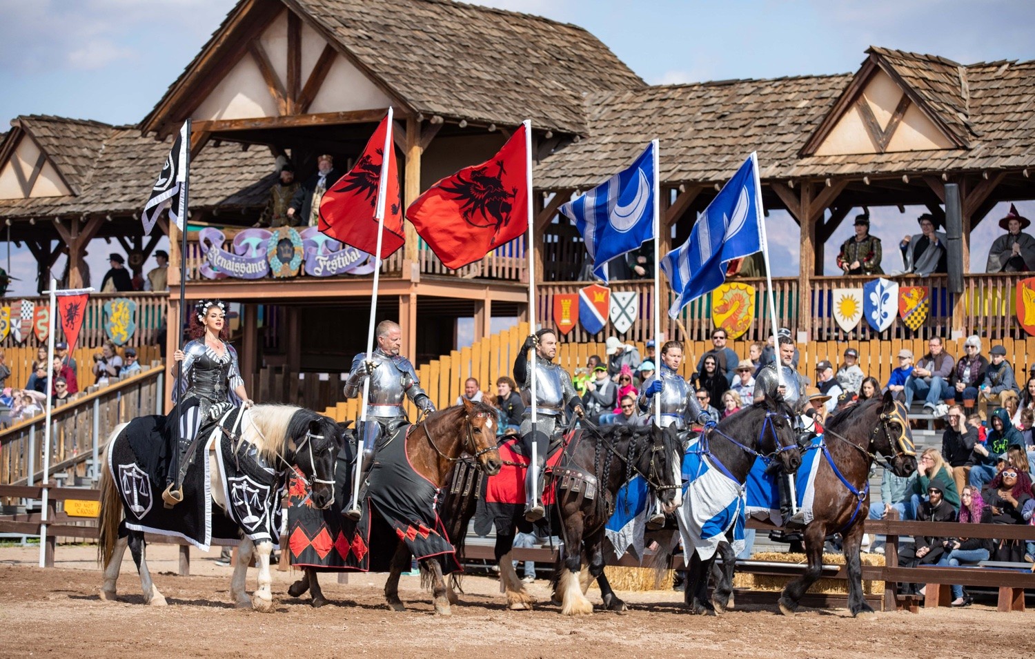 Jousters carrying flags at a Renaissance festival