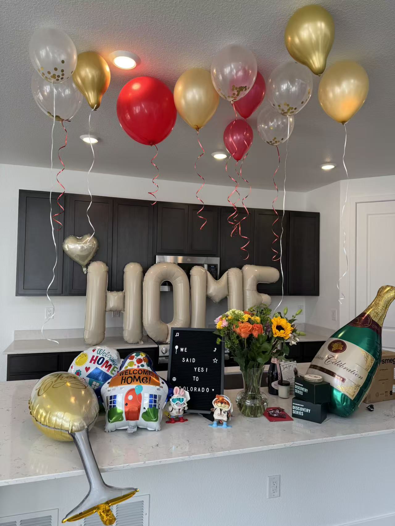 Closing celebration with balloons, flowers, and welcome-home gifts